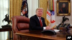 President Donald Trump answers questions from the media after speaking with members of the military by video conference on Christmas Day, Dec. 25, 2018, in the Oval Office of the White House. 