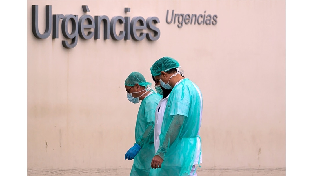 Health workers go bak to work after after a break at La Fe hospital on March 25, 2020, in Valencia.