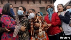 Relatives cry as the bodies of their family members, who died in Saturday's earthquake, are prepared for cremation along a river in Kathmandu, Nepal, April 28, 2015.