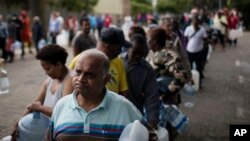 FILE - Residents queue to fill containers with water from a source of natural spring water in Cape Town, South Africa, Feb. 2, 2018. 