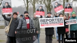 FILE- Members of Journalists Without Borders protest against Azerbaijan's President Ilham Aliyev in Berlin, January 2015. 