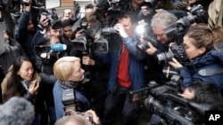 Swedish Chief Prosecutor Ingrid Isgren is surrounded by journalists as she arrives at the Ecuadorian embassy to interview Wikileaks founder Julian Assange in London, Nov. 14, 2016.