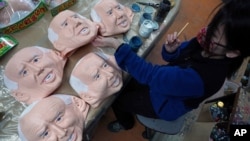 An employee adds details to rubber masks depicting President-elect Joe Biden at the Ogawa Studios in Saitama, north of Tokyo, Wednesday, Nov. 11, 2020. Ogawa Studios, a Japanese manufacturer started making the masks since the middle of October,…