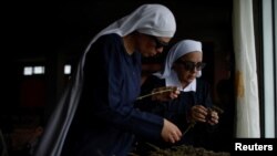 Members of Sisters of the Valley, a non-religious international group check hemp that is drying at a house on the Sisters of the Valley's farm on the outskirts of a village in central Mexico, September 2, 2023. (REUTERS/Raquel Cunha ) 