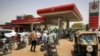 Motorcyclists queue-up for fuel at a gasl station in al-Amarat district of Sudan's capital Khartoum on June 10, 2021. 