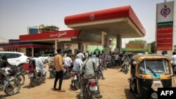 Motorcyclists queue-up for fuel at a gasl station in al-Amarat district of Sudan's capital Khartoum on June 10, 2021. 