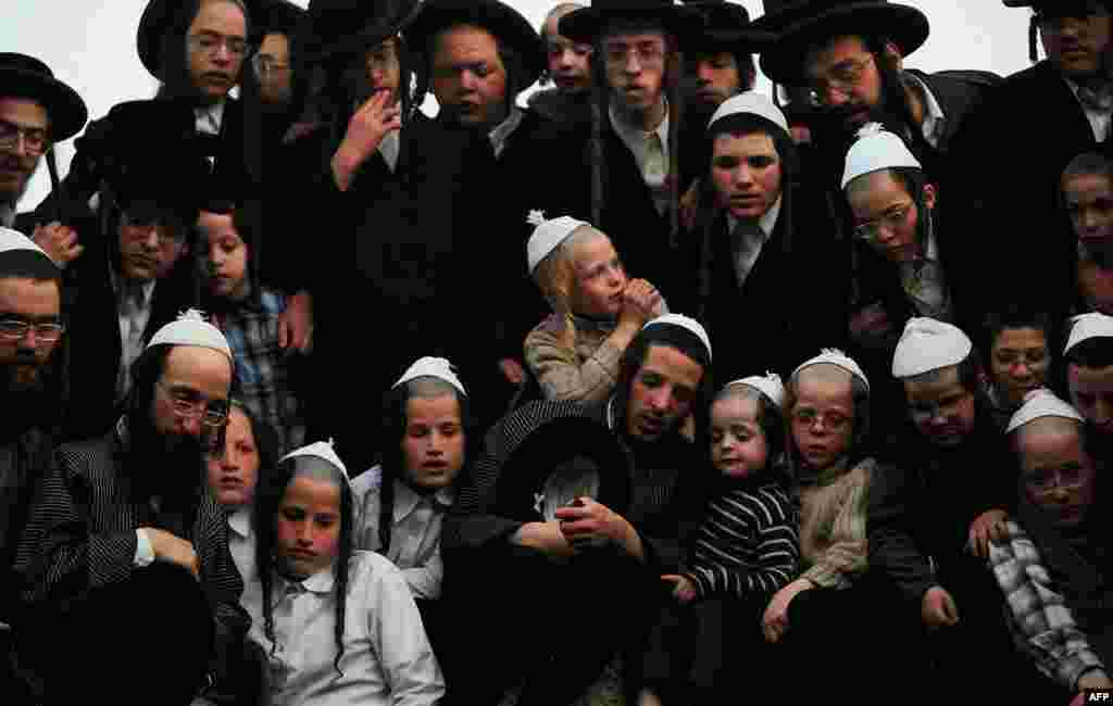Ultra-Orthodox Jews watch others collecting spring water during the traditional Jewish rite of "Mayim Shelanu" in the Jerusalem mountains. The water is used to prepare matzoh, traditional unleavened bread eaten during Passover. (Reuters)