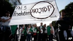 Algerian demonstrators take to the streets in the capital Algiers to protest against the government, in Algeria, Nov. 1, 2019. 
