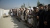 File - Relatives pray for one of three women working for a local radio and TV station who was killed on in attack during her funeral ceremony in Jalalabad, east of Kabul, Afghanistan, March 3, 2021. 
