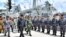FILE - In this Jan. 8, 2020, file photo released by Indonesian Presidential Office, Indonesian President Joko Widodo, center, inspects troops during his visit at Indonesian Navy ship KRI Usman Harun at Selat Lampa Port, Natuna Islands, Indonesia.