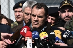 FILE - Greek Minister of National Defense Nikos Panagiotopoulos speaks to journalists in Kastanies on March 1, 2020.