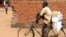 A man carries bags of fertilizer on his bicycle in Lilongwe, Malawi, Monday March 6, 2023. 