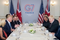 FILE - Britain's Prime Minister Boris Johnson meets then-U.S. President Donald Trump for talks during the G-7 summit in Biarritz, France, Aug. 25, 2019.