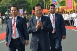 Cambodian Prime Minister Hun Sen, center, greets his government officers during the country's 66th Independence Day from France, at the Independence Monument in Phnom Penh, Cambodia, Saturday, Nov. 9, 2019.