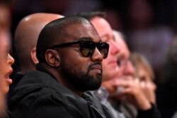 FILE - Rapper Kanye West watches during the second half of an NBA basketball game between the Los Angeles Lakers and the Cleveland Cavaliers Monday, Jan. 13, 2020, in Los Angeles.