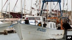 French far-right leader and candidate for the presidential election Marine le Pen waves from a fishing trawler as she arrives from a sea trip in Grau-du-Roi, southern France, April 27, 2017.