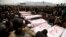 Shi'ite Muslims sit around coffins of victims killed in Saturday's bomb attack, during a funeral at a cemetery in Quetta, February 20, 2013. 