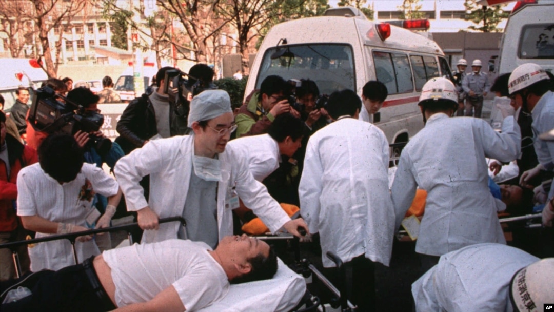 FILE - Subway passengers affected by sarin gas spread in the central Tokyo subways by the Aum Shinrikyo doomsday cult are carried into St. Luke's International Hospital in Tokyo, March 20, 1995. The Japanese cult was popular in Russia in the 1990s but was outlawed. 