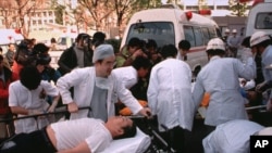 FILE - Subway passengers affected by sarin gas spread in the central Tokyo subways by the Aum Shinrikyo doomsday cult are carried into St. Luke's International Hospital in Tokyo, March 20, 1995. The Japanese cult was popular in Russia in the 1990s but was outlawed. 