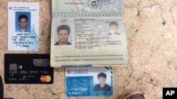 In this photo released by the Egyptian Ministry of Interior on Thursday, Mar. 24, 2016, personal belongings of slain Italian graduate student Giulio Regeni, including his passport, are displayed.