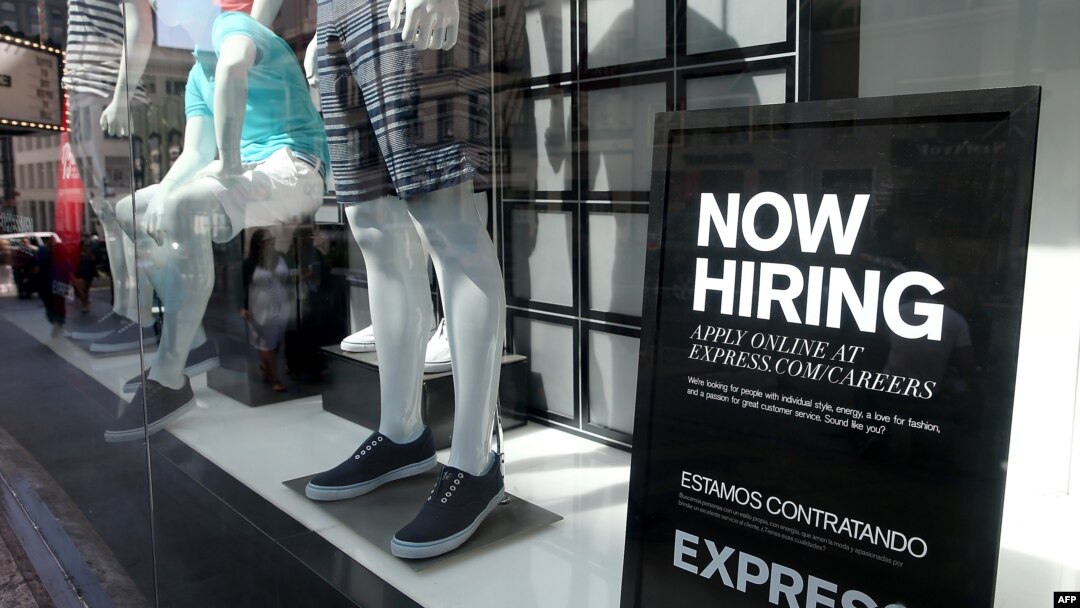 FILE - A now hiring sign is posted in the window of a clothing store on June 6, 2014 in San Francisco, California. 