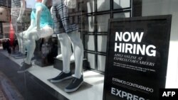 FILE - A now hiring sign is posted in the window of a clothing store on June 6, 2014 in San Francisco, California. 