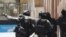 FILE - Armed police officers point as they stand at the ready close to a cafe under siege at Martin Place in Sydney, Australia, Dec. 15, 2014.  