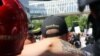 FILE - A person wears a hat of U.S. far-right men's organization Proud Boys during a campaign rally for Patriot Prayer founder and Republican Senate candidate Joey Gibson in Portland, Ore., Aug. 4, 2018.