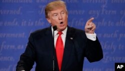 Republican presidential nominee Donald Trump speaks to Democratic presidential nominee Hillary Clinton during the third presidential debate at UNLV in Las Vegas, Oct. 19, 2016.