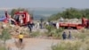 Rescuers and South African Police Service (SAPS) officers carry remains in blue body bags during a rescue operation to retrieve illegal miners from an abandoned gold shaft in Stilfontein on January 13, 2025.