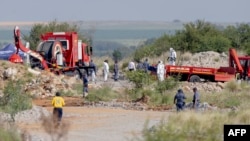 Rescuers and South African Police Service (SAPS) officers carry remains in blue body bags during a rescue operation to retrieve illegal miners from an abandoned gold shaft in Stilfontein on January 13, 2025.