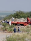 Rescuers and South African Police Service (SAPS) officers carry remains in blue body bags during a recovery operation to retrieve deceased illegal miners from an abandoned gold shaft in Stilfontein, Jan. 13, 2025.