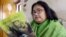 In this file photo taken on March 6, 2003, Indian author Sushmita Banerjee holds one of her novels.