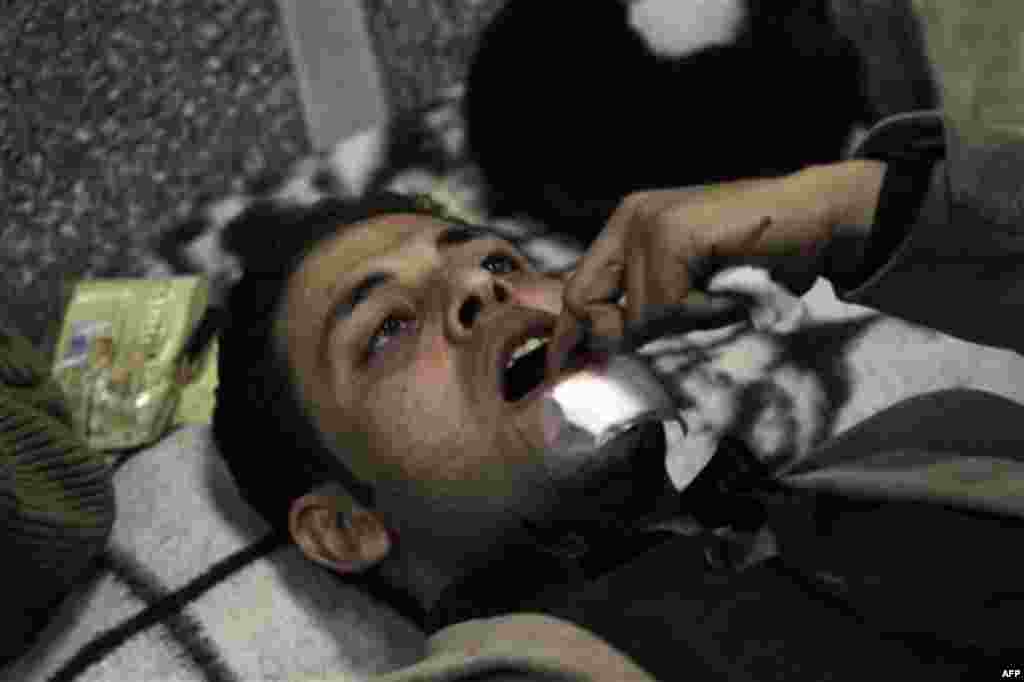 An anti-government demonstrator wounded during clashes with pro-government protesters wait to be seen at a makeshift medical triage station, near Tahrir square, the center of anti-government demonstrations, in Cairo, Egypt, Wednesday, Feb. 2, 2011. Thousa