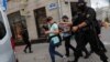FILE - Law enforcement officers detain journalists in Minsk, Belarus, July 28, 2020. Belarus has cracked down hard on news media, deporting some foreign journalists and revoking others' accreditation.