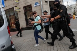 FILE - Law enforcement officers detain journalists in Minsk, Belarus, July 28, 2020. All members of the media were released after being brought to and questioned at a local police station.