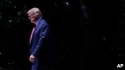 FILE - President Donald Trump walks out of the Oval Office onto the South Lawn of the White House in Washington, May 24, 2019.