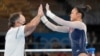 Sunisa Lee, of the United States, greets her coach Jeff Graba after performing on the uneven bars during the artistic gymnastics women's all-around final at the 2020 Summer Olympics, July 29, 2021, in Tokyo.