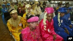 FILE - Indonesian couples wait for their turn to wed during a 47-couple mass wedding ceremony in Jakarta, Indonesia, in 2005.