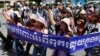 Cambodian activists shout slogans during a march toward the National Assembly, in Phnom Penh, Cambodia, Thursday, May 29, 2014.