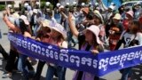 Cambodian activists shout slogans during a march toward the National Assembly, in Phnom Penh, Cambodia, Thursday, May 29, 2014.