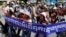 Cambodian activists shout slogans during a march toward the National Assembly, in Phnom Penh, Cambodia, Thursday, May 29, 2014.