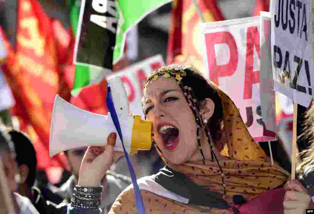 A woman shouts slogans using a megaphone during a demonstration stage in support of the independence of the Western Sahara in Madrid as the 39th European Conference for support and Solidarity with the Saharawi People (EUCOCO) is held. The Western Sahara is a territory bordered by Morocco and Algeria and disputed by Spain and Morocco who both claim sovereignty.