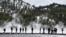 FILE - Visitors are seen at Grand Prismatic Spring in Yellowstone National Park, Wyoming, May 1, 2021.