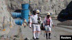 FILE - Workers return from a shift at Zimplats' Ngwarati Mine in Mhondoro-Ngezi, May 30, 2014.