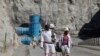 FILE - Workers return from a shift at Zimplats' Ngwarati Mine in Mhondoro-Ngezi, May 30, 2014.