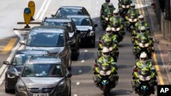 Traffic police on motorcycles ride in formation during a visit by the Chinese President in Hong Kong, June 29, 2017.