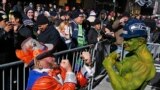A fan of the Seattle Seahawks jokes with a fan of the Denver Broncos at the Super Bowl Boulevard fan zone ahead of Super Bowl XLVIII in New York, Jan. 30, 2014.