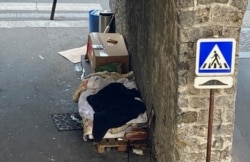 Businesses shut by rolling lockdowns have become new homeless shelters, like this makeshift shelter in Paris. (Lisa Bryant/VOA)