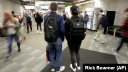 In this November 14, 2019, photo, students walk on the campus of Utah Valley University, in Orem, Utah.